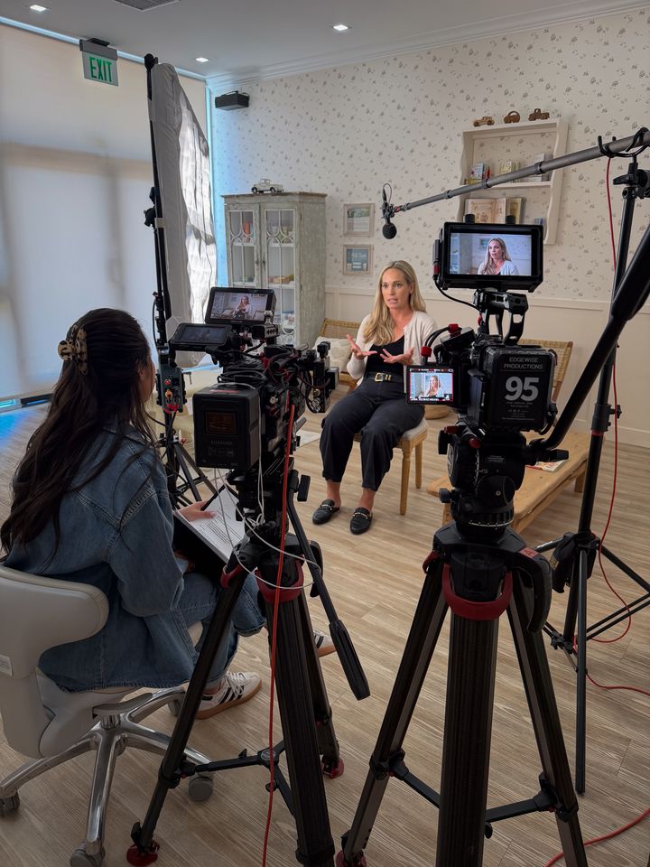 An interview being filmed at Milk Tooth, seen from behind the two cameras and their monitors