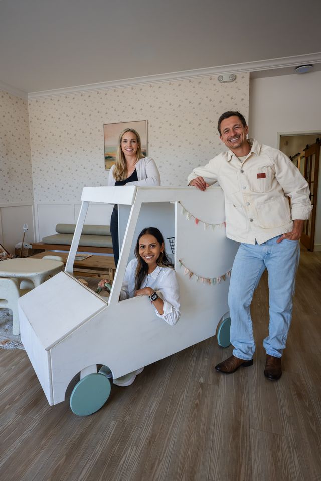 The three doctors with the play milk truck in the Milk Tooth lobby